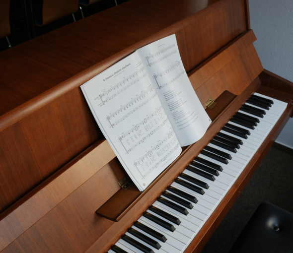 A piano with a music book